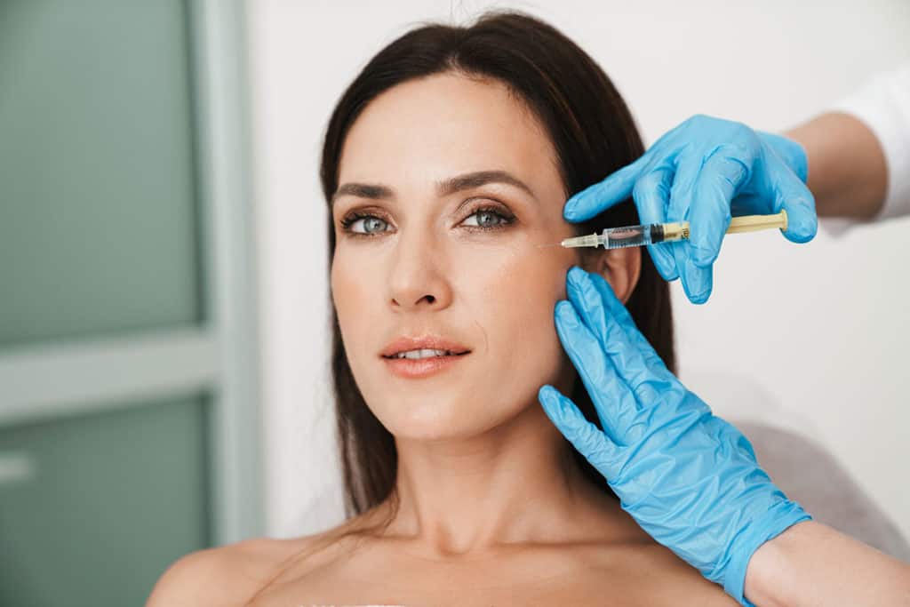 Woman receiving facial injection