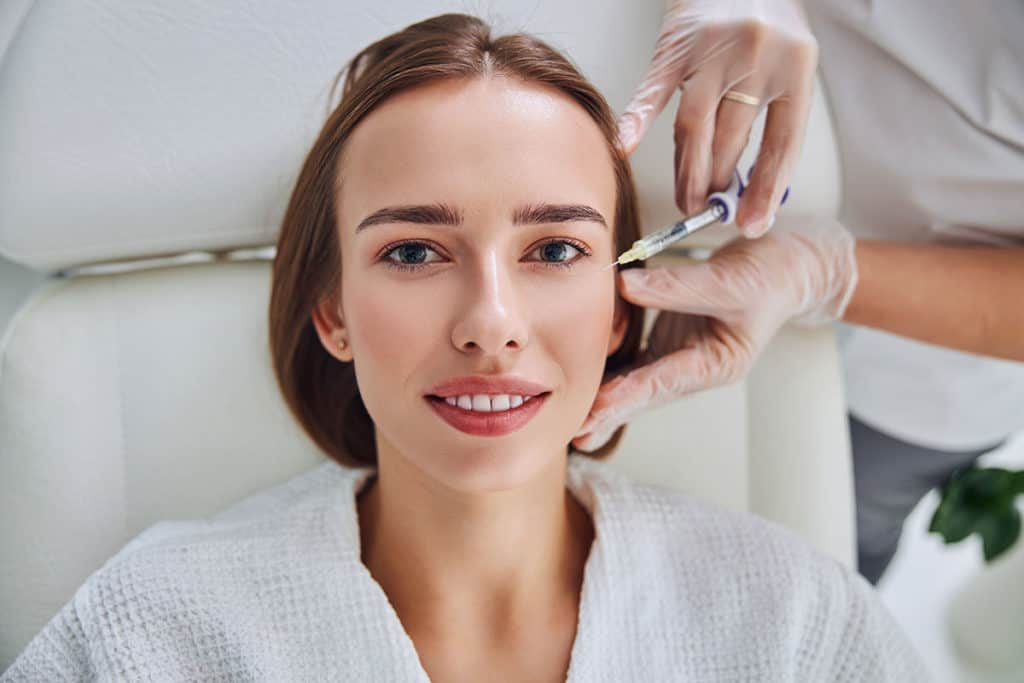 Woman receiving facial injection