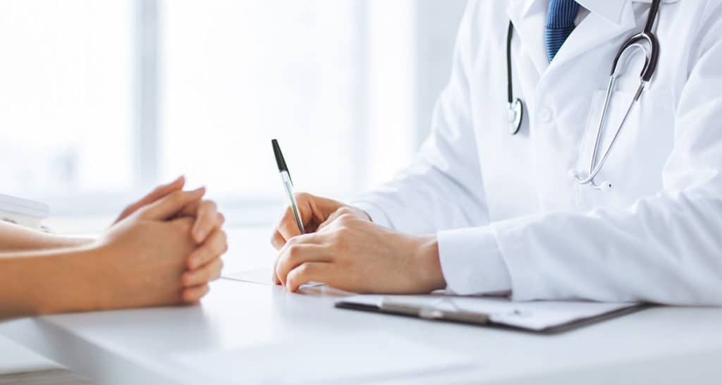 Photo of doctor and patient at a desk